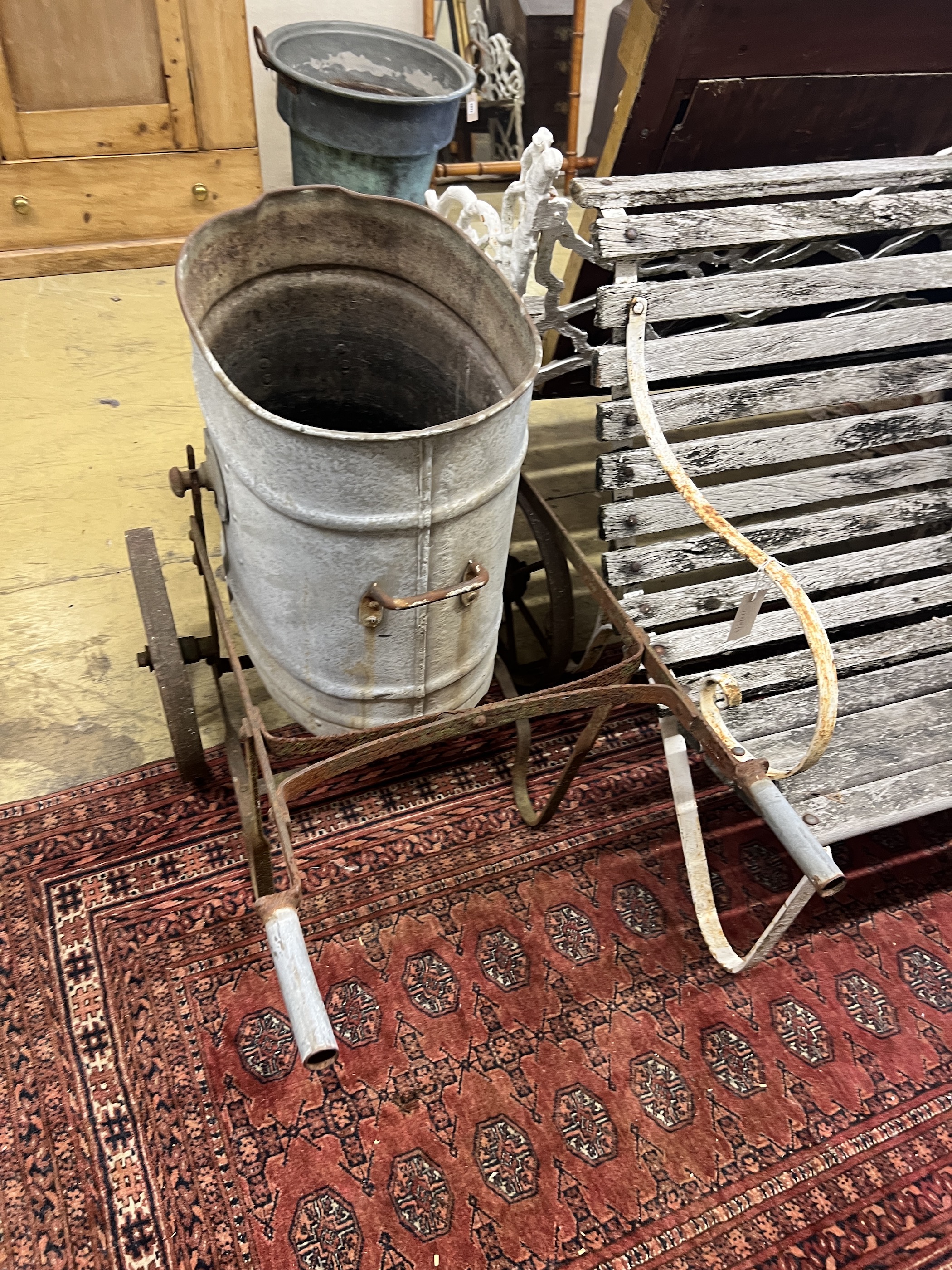 A Victorian galvanised and wrought iron water barrow, height 73cm together with a churn